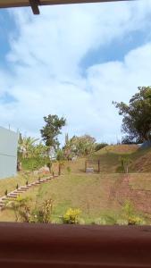 a view of a field from a window at Pousada das Neves in Miguel Pereira