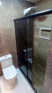 a small bathroom with a toilet and a sink at Pousada das Neves in Miguel Pereira +24 photos
