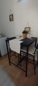 a black and white table and chairs in a kitchen at Le Dimore Nel Borgo in Casamassima +15 photos