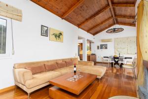 a living room with a couch and a table at Villa Glan Y Mor in Elounda
