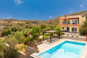 an image of a house with a swimming pool at Villa Glan Y Mor in Elounda