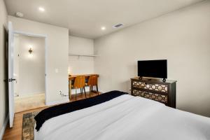 a bedroom with a bed and a flat screen tv at Desert Blue River Retreat in Palm Springs +25 photos