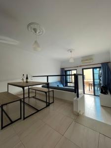 a living room with a bed and a table at La Lajita Vacation Home in Pájara