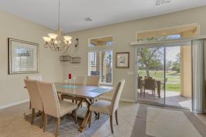 a dining room with a table and chairs at Golfing & Festival Lover's Paradise in Desert Groves Mobile Home Park