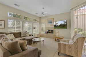 a living room with a couch and a table at Golfing & Festival Lover's Paradise in Desert Groves Mobile Home Park
