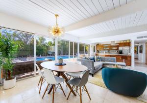 a living room with a table and chairs at Serenity in Sunmor in Palm Springs