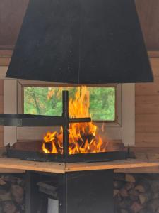 a fireplace with a fire in it at Stuga i Puolanka in Puolanka