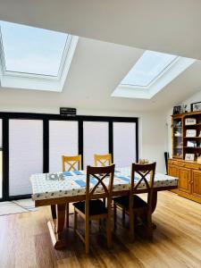 a dining room with a table and chairs and a skylight at The Henge House in Salisbury