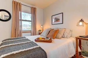 a bedroom with a bed with a tray on it at Waterfront with Spa and Lake Access in Saint-Damien +21 photos