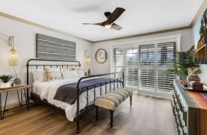 a bedroom with a bed and a ceiling fan at Cozy Ranch-Style Condo in Palm Springs +22 photos