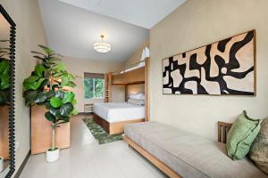 a bedroom with a bed and a couch in it at Webber East in Austin