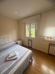 a bedroom with a bed with a towel on it at Apartmento en Xove in Jove
