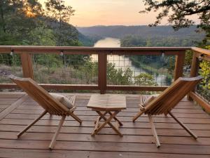 two chairs and a table on a deck with a view at NEW Romantic CLIFF GLAMPING w Vista Views of WHITE RIVER, Minutes to fishing and hikes!  +34 photos