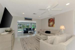 ein Wohnzimmer mit einer Couch und einem Deckenventilator in der Unterkunft Cape Aqua Retreat in Siesta Key