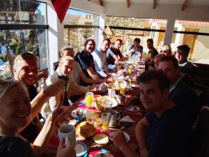 a group of people sitting around a long table at Palacio del Inca Lodge Isla del Sol in Comunidad Yumani