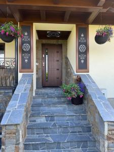 a front door of a house with stairs and potted plants at Suchowianka Ski&Relax in Białka Tatrzańska