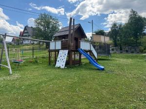 a playground with a house and a slide at Suchowianka Ski&Relax in Białka Tatrzańska