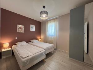 a bedroom with a large bed and a chandelier at Le temps de vivre in Mormoiron +30 photos