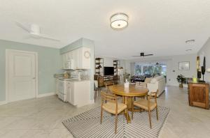 a kitchen and living room with a table and chairs at Calm Seas in Englewood