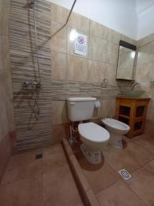 a bathroom with a toilet and a shower at Habitaciones en Complejo Turístico Cruz Mendoza in Tilcara
