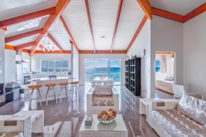 a living room and kitchen with a view of the ocean at Ocean Spray Villas in Rarotonga