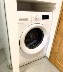 a white washer and dryer in a room at Tiny House am Ranziger See in Tauche