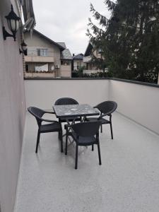 a table and four chairs on a patio at Apartman Ruža in Sarajevo
