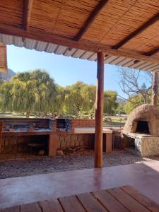 an outdoor seating area with a stone pizza oven at Habitaciones en Complejo Turístico Cruz Mendoza in Tilcara