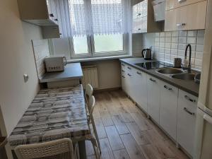 a small kitchen with a table and a sink at Hostel Berberysowa in Wrocław +14 photos