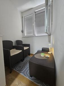 a small room with two chairs and a table at Bilino polje in Zenica +12 photos