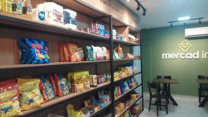 a store filled with shelves filled with food at Apartamento bem localizado in Vitória +9 photos