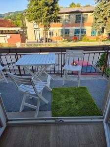a picnic table and chairs on a balcony at Urban Home Visoko in Visoko