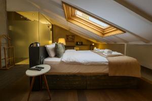 a bedroom with a large bed with a skylight at Aleksandr Pera Hotel in Istanbul