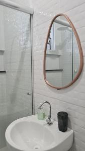 a bathroom with a sink and a mirror at Apartamento no centro de Boa Vista in Boa Vista