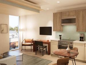 a kitchen with a table and a living room at Mint House Tampa - Downtown in Tampa