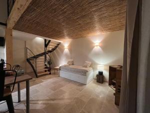 a bedroom with a bed and a spiral staircase at Gîte les Millères - Le Duplex Cosy in Villemur-sur-Tarn +2 photos