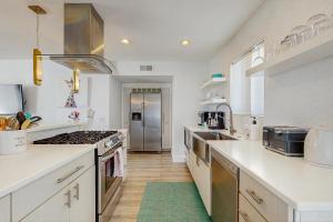 a kitchen with white counters and a stove top oven at Palm Breeze in Palm Desert