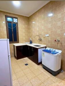 a kitchen with a sink and a stove at فيو بلس للشقق المخدومة in Khamis Mushayt