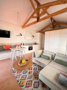a living room with a couch and a table at Lezíria Houses - Ribatejo in Chamusca