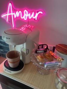 a kitchen counter with a mixer and a cup of coffee at Love room - Casa Lova in Saussan