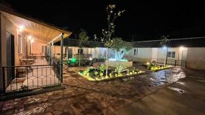 a courtyard at night with a large vase in the middle at Agrotourism Isak in Finiq