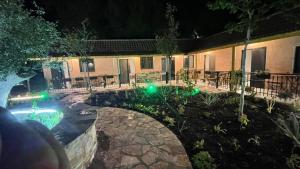 a house with a swimming pool at night at Agrotourism Isak in Finiq