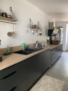 a kitchen with a sink and a counter at MAISON DE VILLE à Saint-Junien in Saint-Junien +17 photos