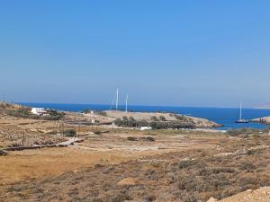 a view of a beach with a boat in the water at Livadi BEACH HOUSES 1 in Chora Folegandros