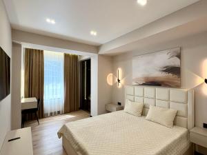 een slaapkamer met een bed en een bureau in een kamer bij Avenue Boutique Luxury N4 in Chişinău