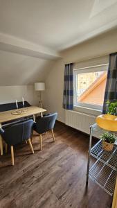 a room with a table and chairs and a window at Appartements Luna in Schladming