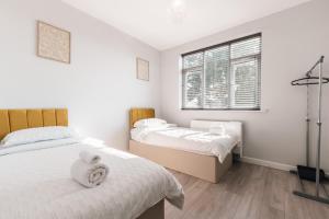 a bedroom with two beds and a window at Shirley 2 Bed Apartment in Southampton