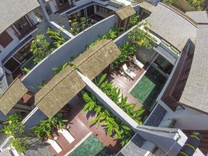 an overhead view of a building with a courtyard with plants at Tolgay Living Villas in Seminyak