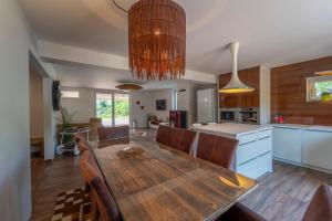 a kitchen and dining room with a wooden table at Chata Manička in Námestovo