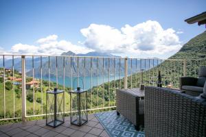 a balcony with a view of the water and mountains at L'angolo di Fonteno in Fonteno +28 photos